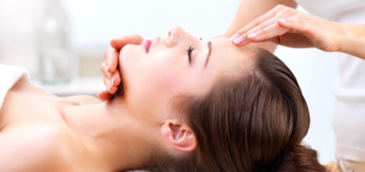 Hands massaging female face at the spa